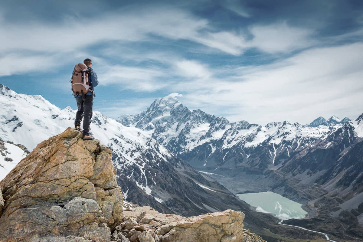 man hiking on top of a snowy mountain in Denver