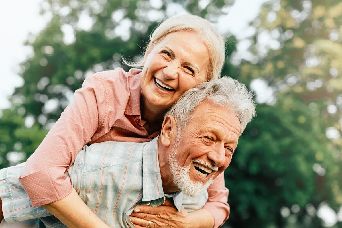 happy senior couple enjoying each others company outdoors