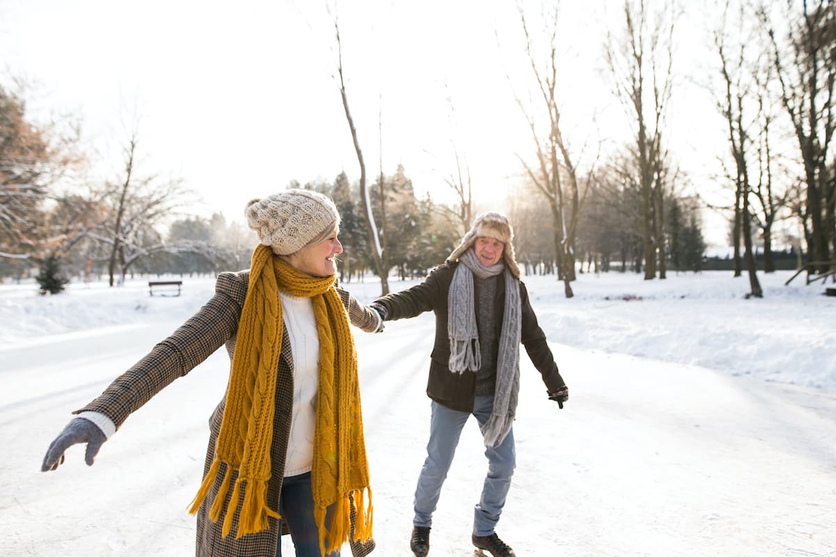 senior couple ice skating outdoors