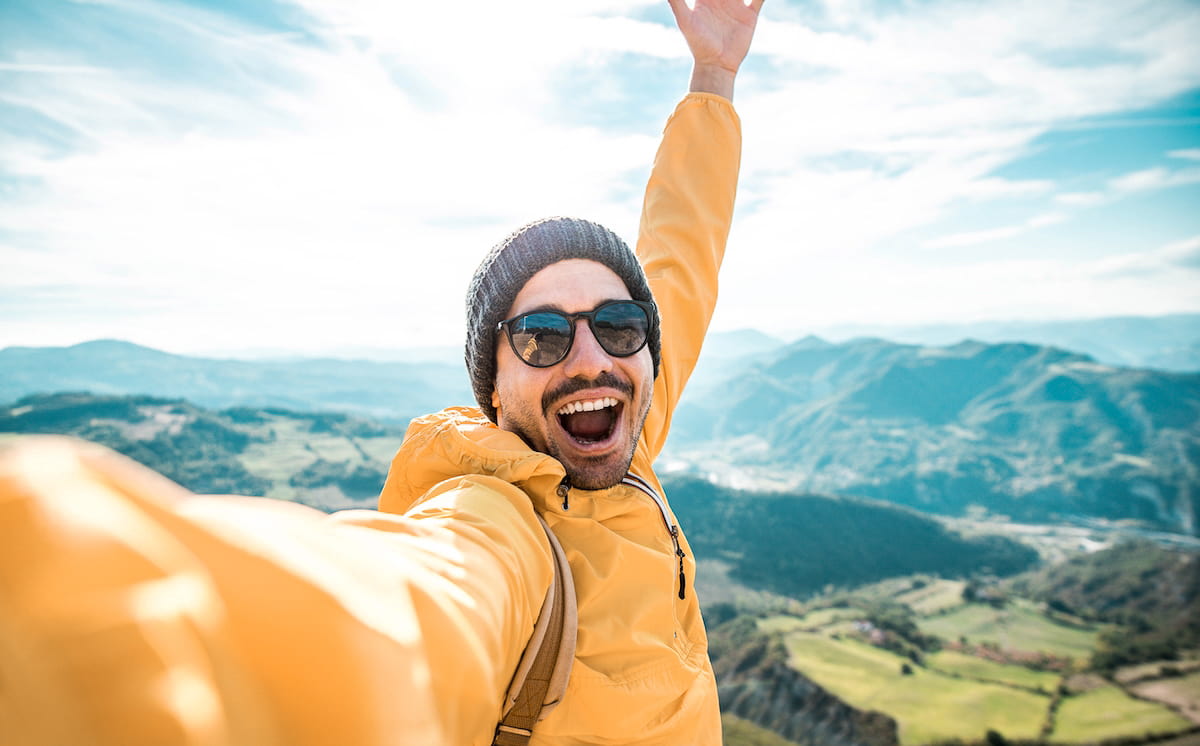 happy man hiking a mountain