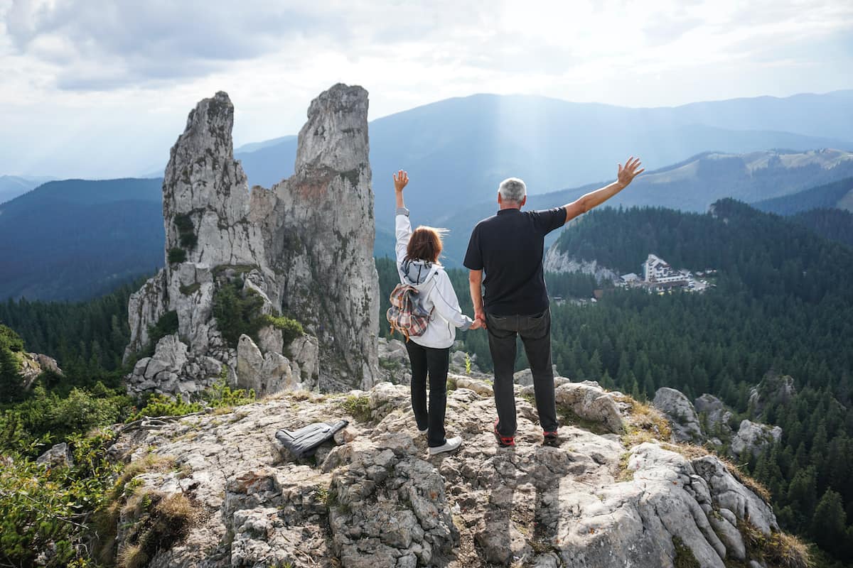 senior couple hiking on a trail and looking into the distance