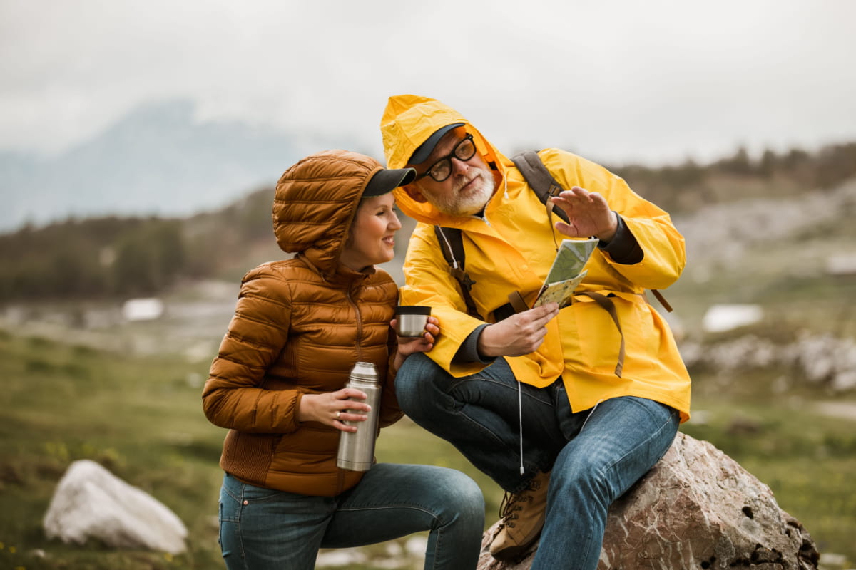 couple hiking and looking at map